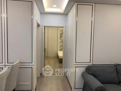 Modern apartment interior with stylish furniture and sleek design, showcasing a cozy living area and hallway.
