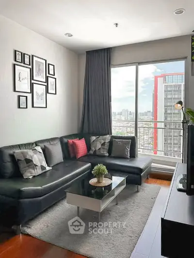 Modern living room with city view, stylish decor, and cozy seating area.