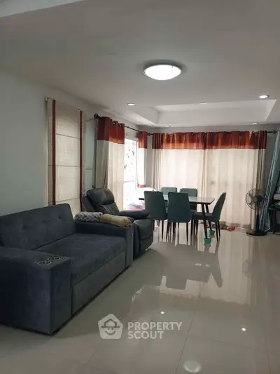 Spacious living room with modern furniture and large windows for natural light.