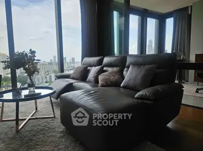 Luxurious living room with panoramic city views and modern furnishings.