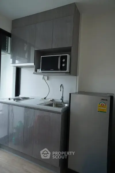 Modern compact kitchen with sleek cabinets and appliances
