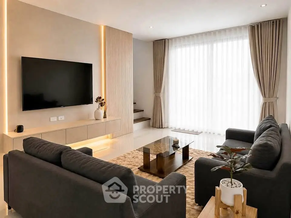 Modern living room with sleek furniture and large TV, featuring elegant curtains and warm lighting.
