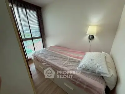 Cozy bedroom with natural light and modern decor in a stylish apartment.