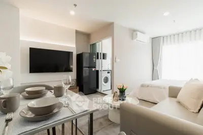 Modern studio apartment with open layout, featuring a cozy living area, dining space, and compact kitchen.