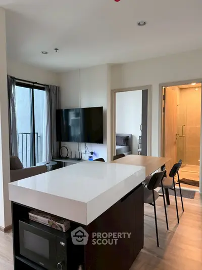 Modern open-plan living room with kitchen island and sleek decor