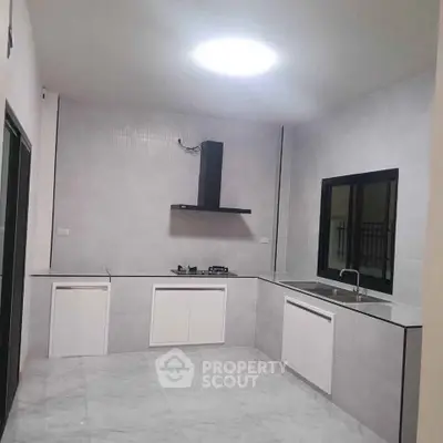 Modern kitchen with sleek design, featuring gas stove and ample counter space.