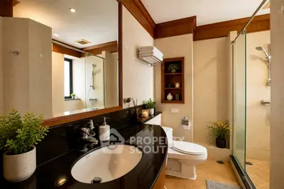 Luxurious bathroom with elegant fixtures and spacious shower area