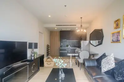 Modern living room with open kitchen, stylish decor, and elegant lighting in a contemporary apartment.