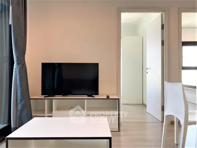 Modern living room with sleek TV setup and minimalist furniture design.