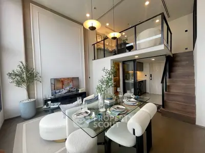 Luxurious modern living room with mezzanine, elegant dining area, and stylish decor