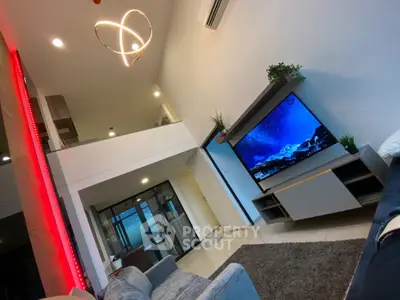 Modern living room with high ceiling and stylish lighting