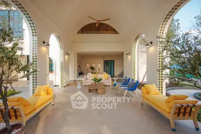 Luxurious open-air living space with elegant arches and vibrant decor, perfect for relaxation and entertaining.
