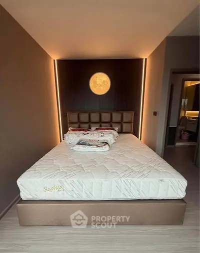 Modern bedroom with stylish lighting and comfortable bed in a contemporary apartment.