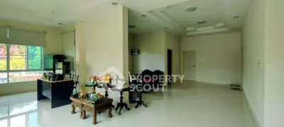 Spacious living room with elegant decor and large windows offering natural light.