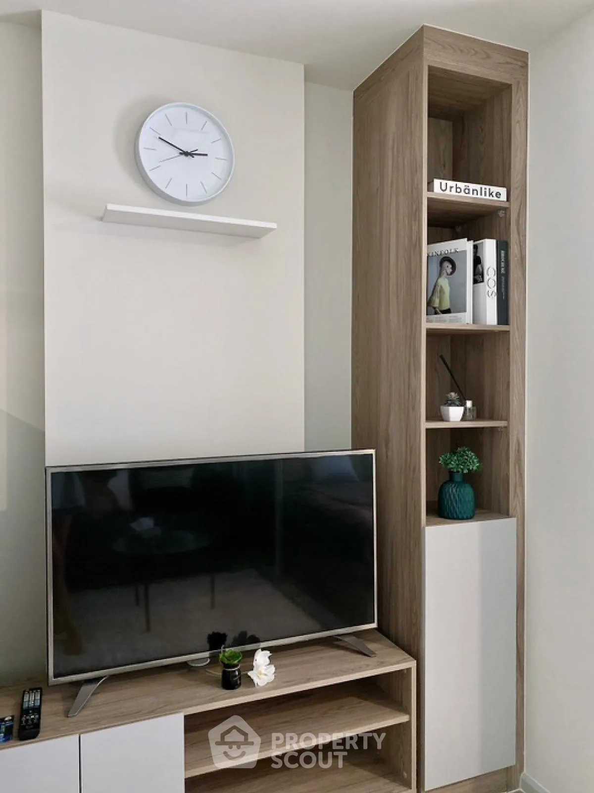 Modern living room with sleek TV setup and stylish shelving unit