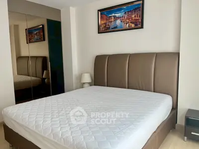Spacious bedroom with elegant decor and large mirrored wardrobe