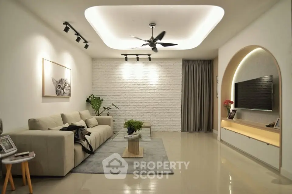Modern living room with stylish decor, cozy sofa, and elegant lighting