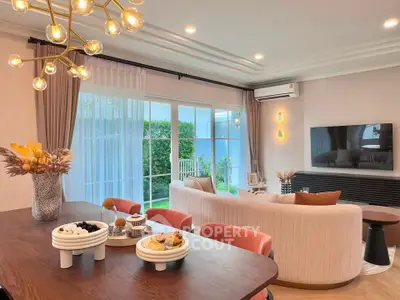 Luxurious living room with modern decor, large windows, and garden view, perfect for relaxation and entertainment.