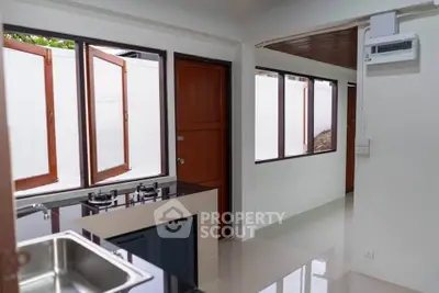 Modern kitchen with sleek design and gas stove in a bright, airy space.