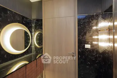 Luxurious modern bathroom with elegant lighting and marble accents