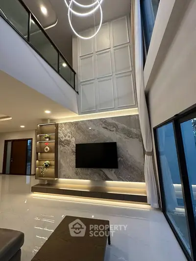 Luxurious modern living room with high ceilings and elegant lighting