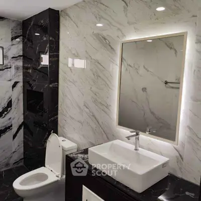 Luxurious modern bathroom with marble walls and sleek fixtures