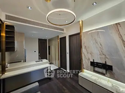 Modern kitchen with sleek design and marble accents, featuring open layout and stylish lighting.