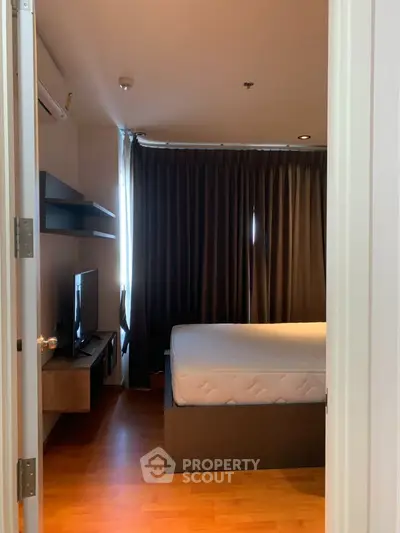 Cozy bedroom with modern furnishings and natural light, perfect for relaxation and comfort.