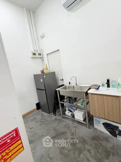 Modern kitchen with stainless steel sink and fridge in minimalist design