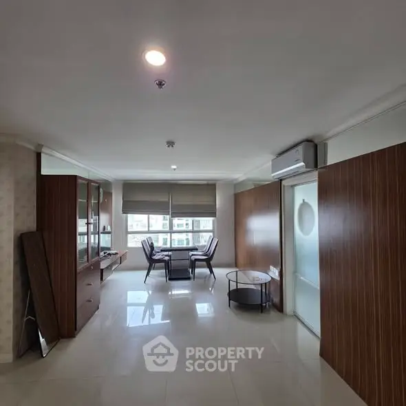 Spacious living room with modern furniture and large windows offering natural light.