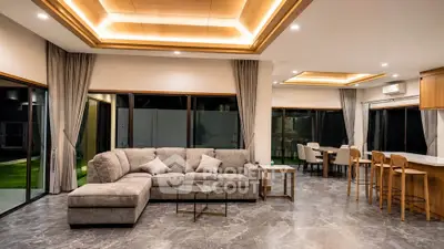 Luxurious open-plan living room with modern decor and elegant lighting