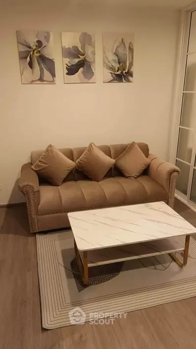 Elegant living room with plush sofa and modern coffee table, perfect for cozy gatherings.