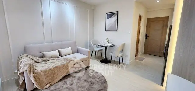 Modern living room with cozy sofa, elegant decor, and dining area in stylish apartment.