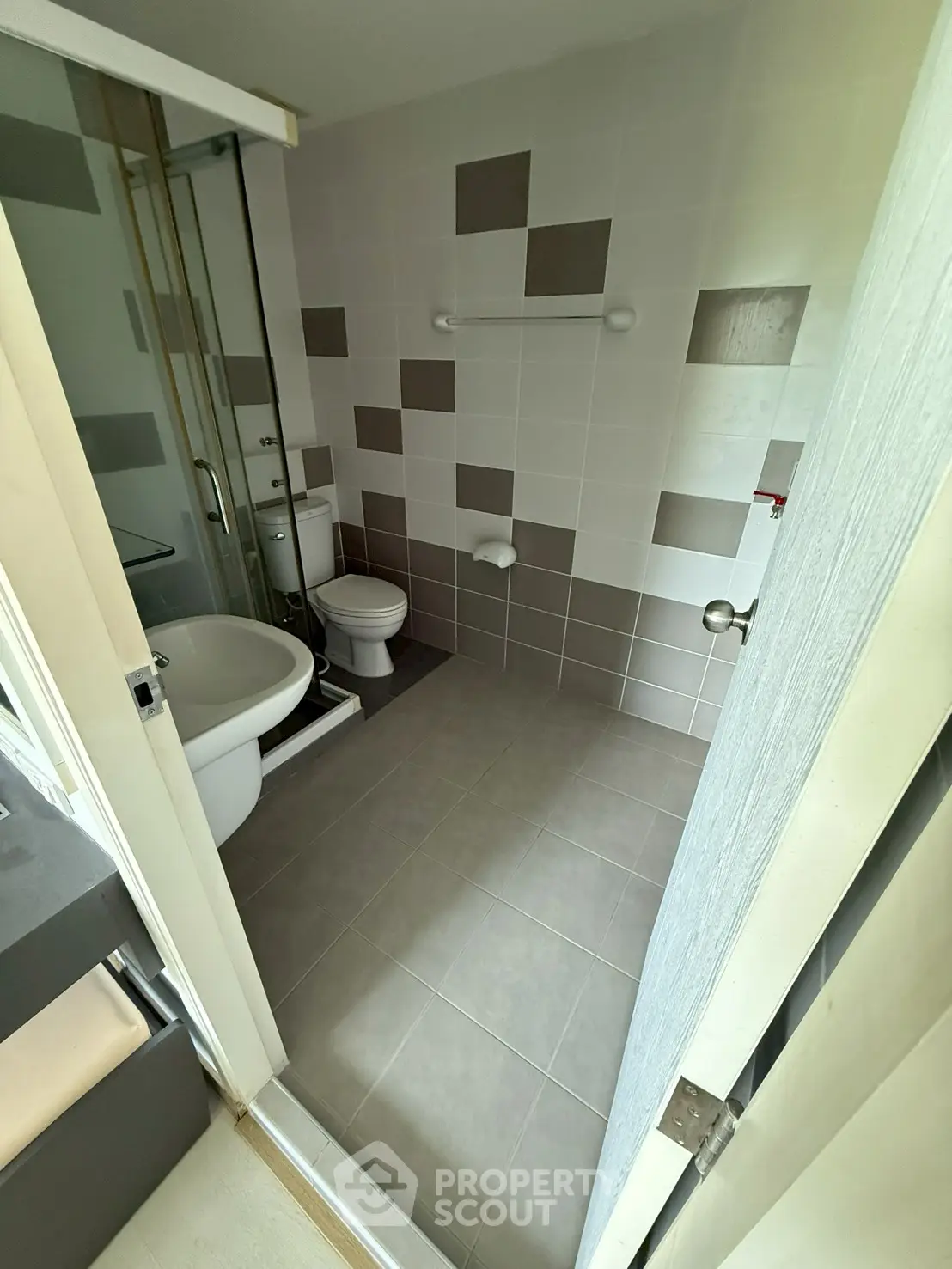 Modern bathroom with sleek tile design and compact layout