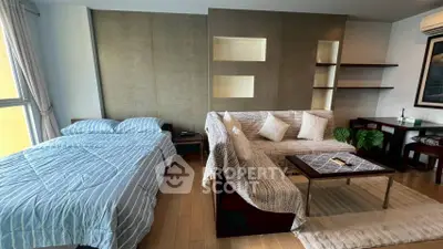 Modern studio apartment with cozy bed and stylish living area