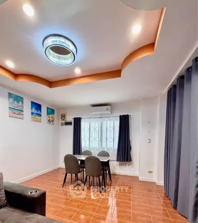 Modern living room with stylish ceiling light and cozy dining area