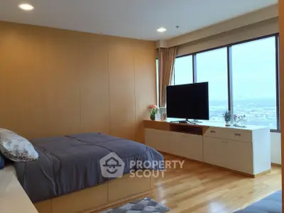 Spacious bedroom with panoramic city view and modern decor