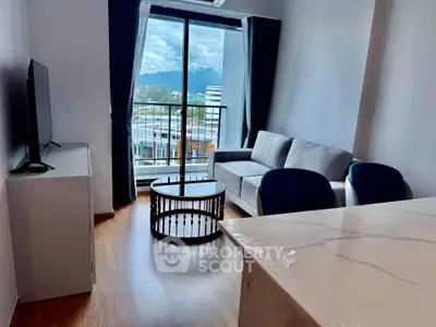 Modern living room with mountain view, stylish furniture, and natural light.