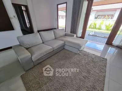 Spacious living room with cozy sectional sofa and garden view