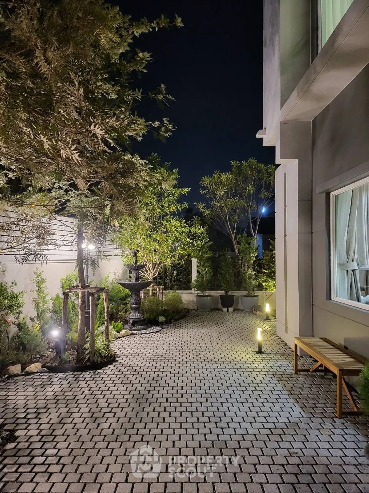 Charming night garden with elegant paving and ambient lighting