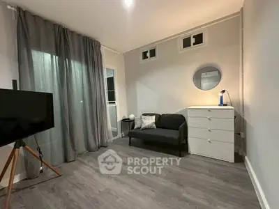 Modern living room with sleek flooring, cozy sofa, and stylish decor