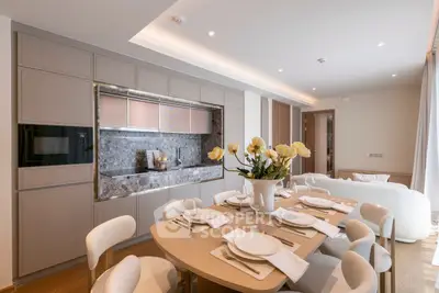 Luxurious open-plan kitchen and dining area with elegant decor and modern appliances.