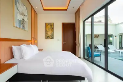 Luxurious bedroom with pool view and elegant decor in modern villa