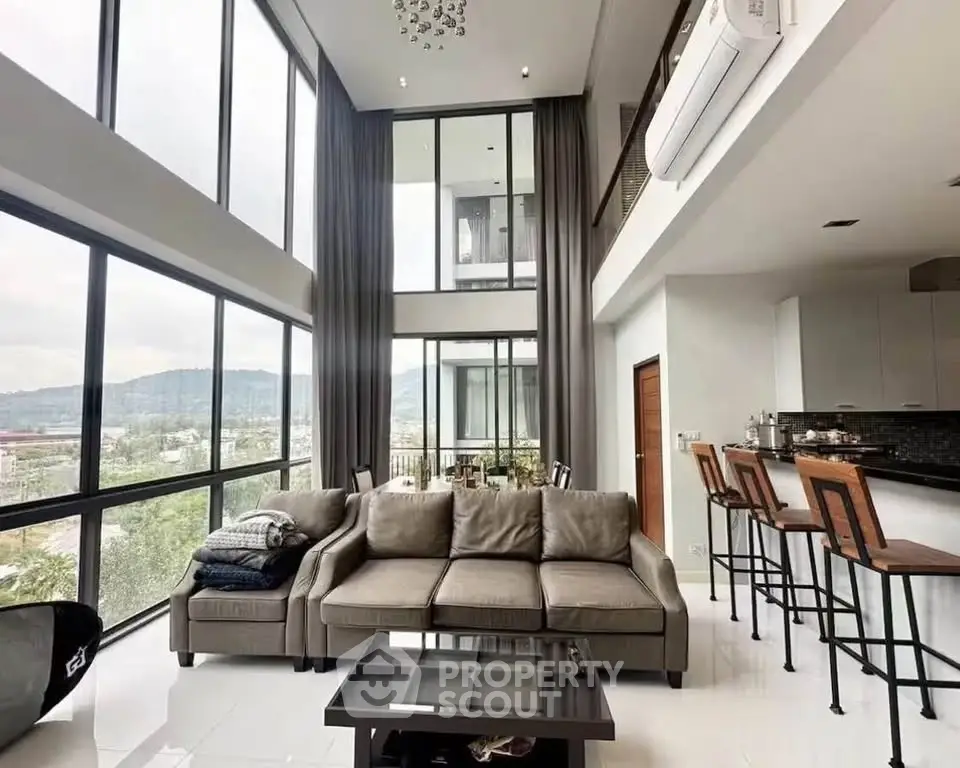 Luxurious modern living room with high ceilings and panoramic windows offering stunning views.