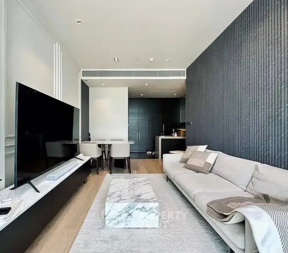Modern living room with sleek design, featuring a large TV, stylish sofa, and elegant decor.
