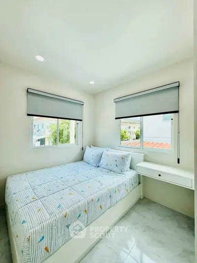 Bright and cozy bedroom with modern decor and large windows