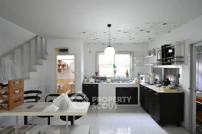 Spacious kitchen with modern black and white cabinetry and ample natural light.
