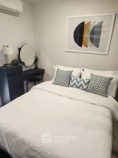 Cozy bedroom with modern decor and stylish bedding in a contemporary apartment.