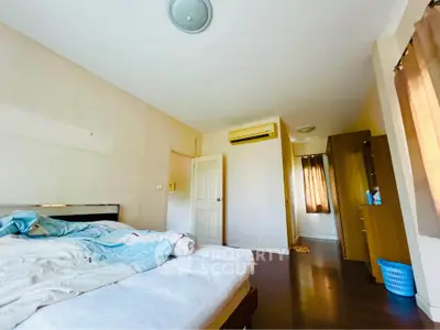 Spacious bedroom with natural light and modern furnishings in a cozy apartment.