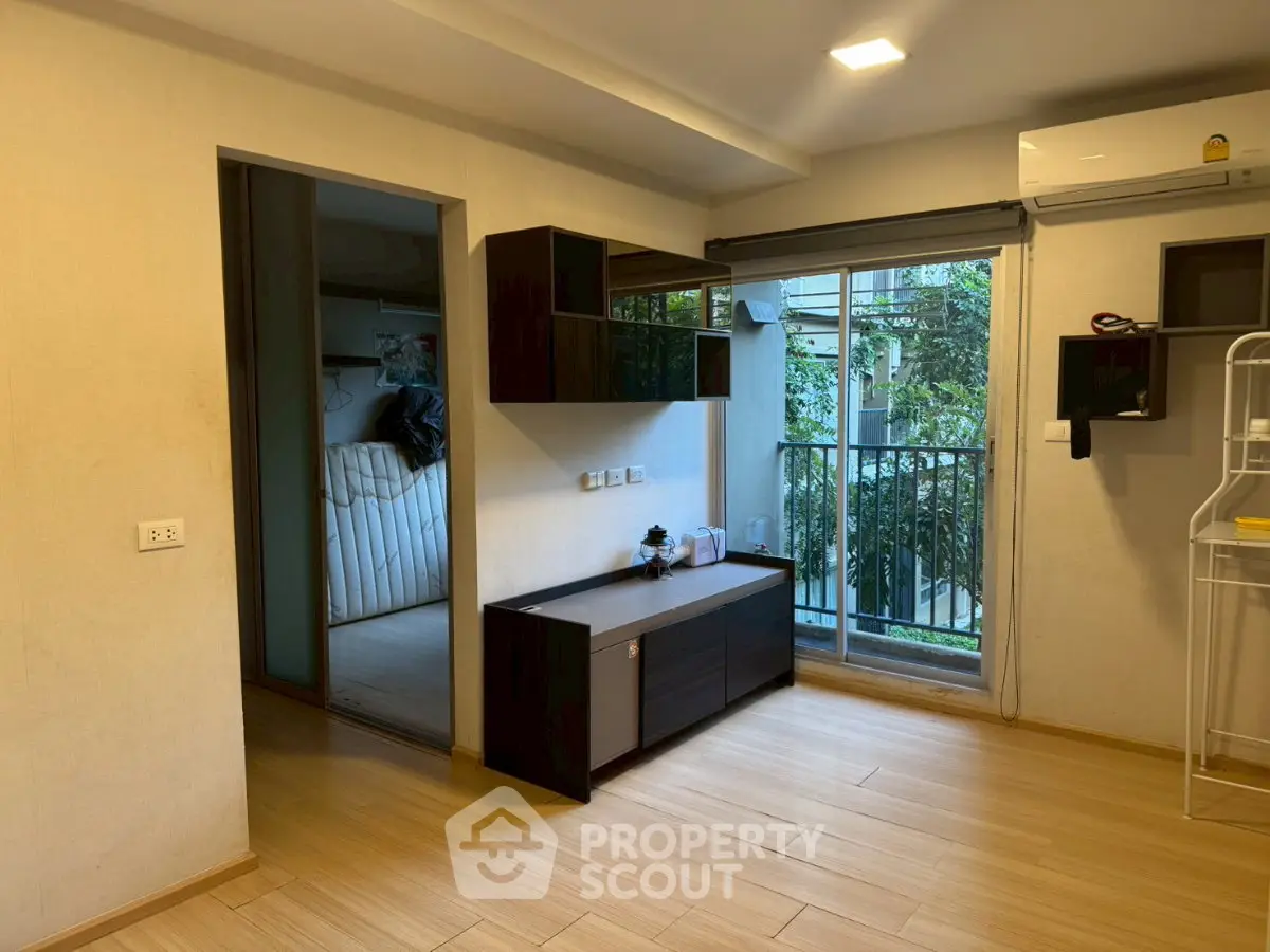 Modern living room with balcony access and sleek wooden flooring